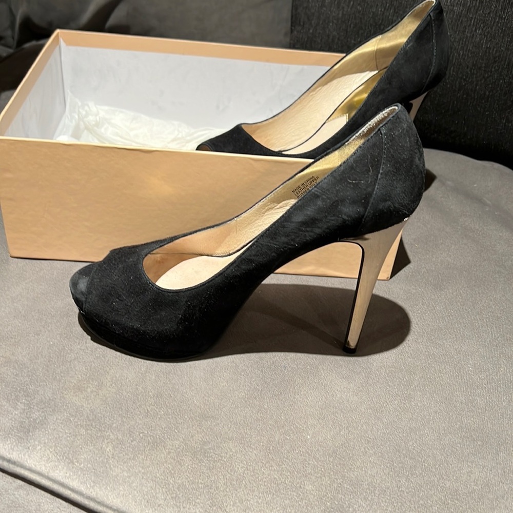 Used beautiful black suede and gold heel bump.